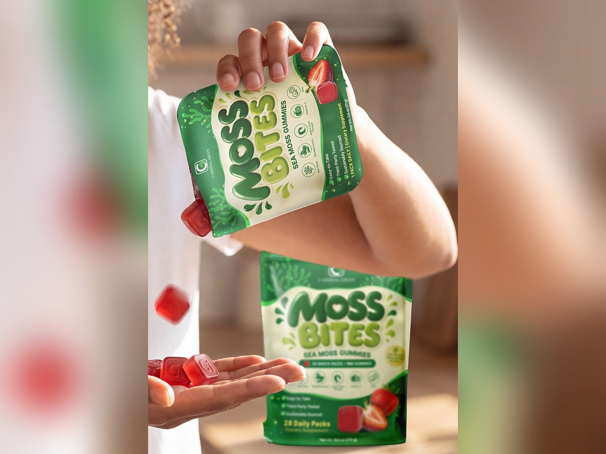 A Moss Bites daily snack pack torn open and poured into a palm