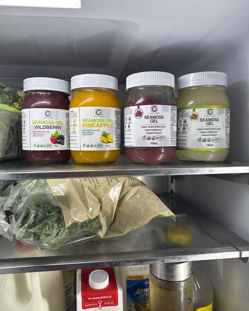 Four jars of CGI-Green SeaMoss Gel on a refrigerator shelf, photographed by customer Andrea Moore