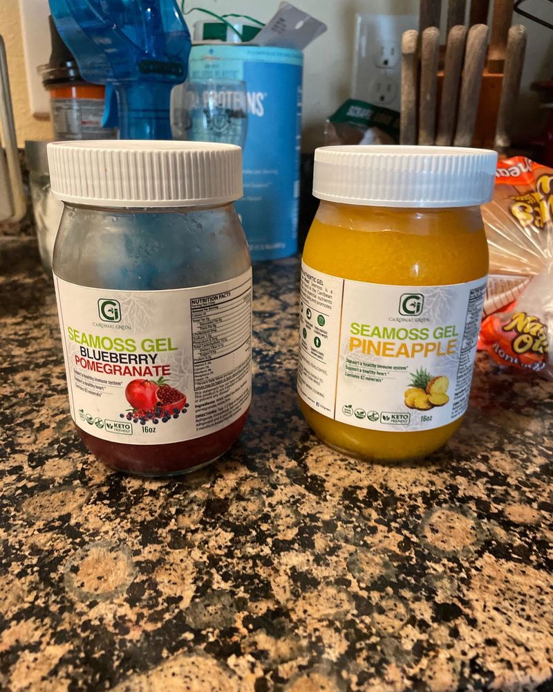 Two jars of CGI-Green SeaMoss Gel on a kitchen counter, photographed by customer Ann Loyd