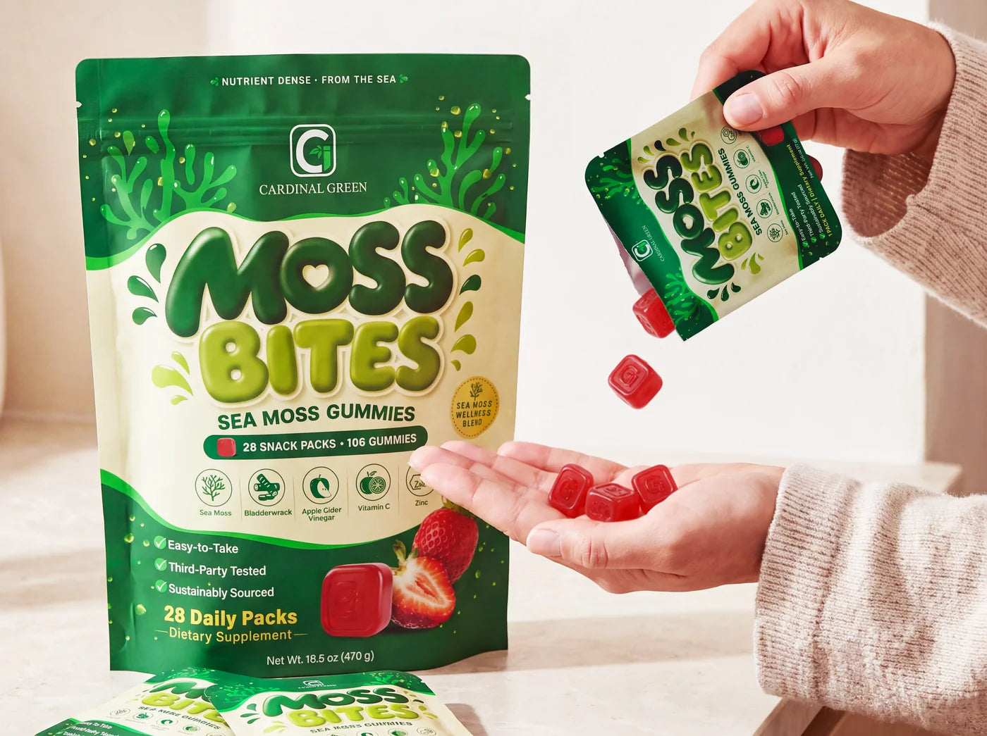 A Moss Bites pouch on a kitchen counter while a daily pack is poured into an open hand