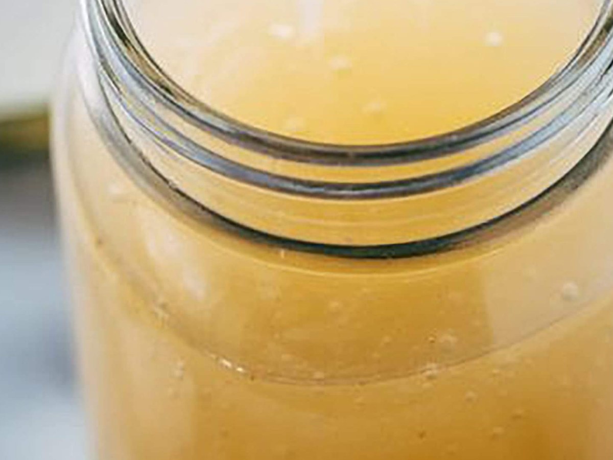 A jar of freshly made CGI-Green sea moss gel, thick enough to hold its shape